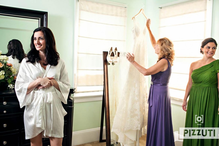 Getting Ready - Bride's Mom Holding Wedding Dress