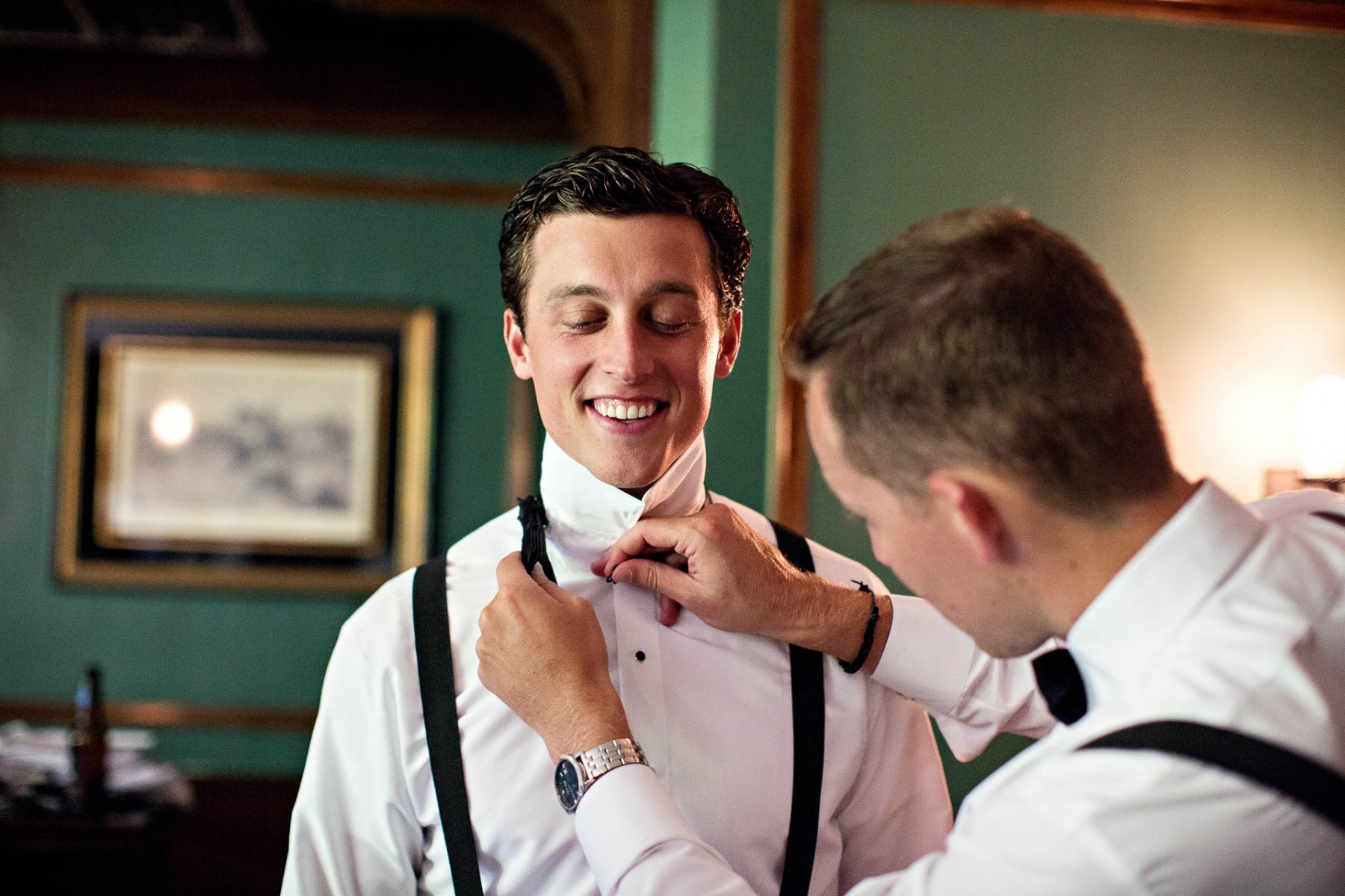 groomsmen-tying-grooms-bowtie