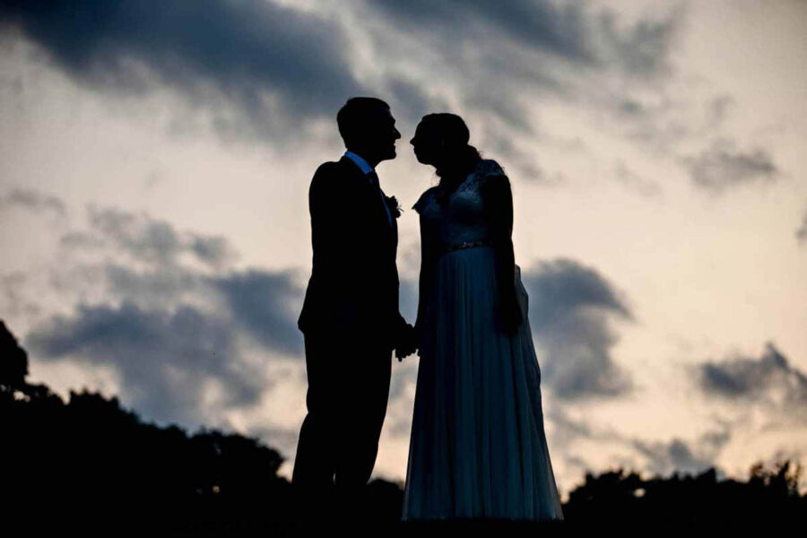 portrait silhouette bride groom sky